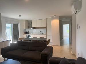 a living room with a couch and a table at Baden Resort Bašanija, Umag-with Sea View, Parking and 300m from the beach in Bašanija