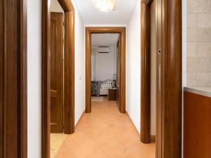 a hallway with wooden doors and a hallway with a hallwayngthngthngthngthngth at B&B ADU Civitavecchia in Civitavecchia