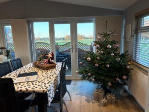 a christmas tree in a dining room with a table at The Lodge in Congleton
