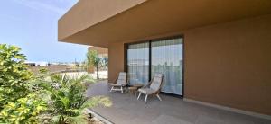 a patio with chairs and a table on a house at Natural Beatriz Luxury Villa Baby Package Included in Lajares