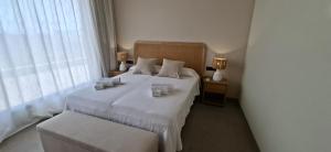 a bedroom with a white bed and a window at Natural Beatriz Luxury Villa Baby Package Included in Lajares
