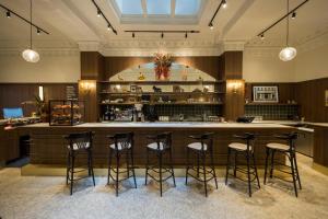 a bar in a restaurant with stools at Hotel Victoria in Toronto