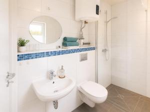a white bathroom with a toilet and a sink at Schwedenglück - Wald-Auszeit für 2 in Dahlen