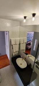 a bathroom with a sink and a mirror at Le Pavillon Hotel in Paris +77 photos