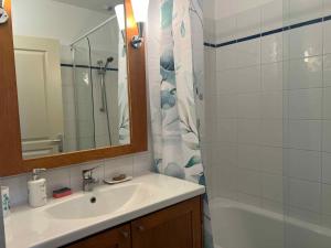 a bathroom with a sink and a shower curtain at Résidence la Marquise in Trébas