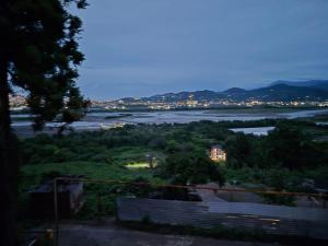 a view of a river with a city and a town at Hillside House Overlooking Batumi in Charnali