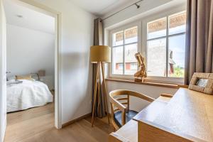 a bedroom with a bed and a table and a lamp at Freischwimmer in Wieck