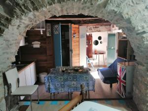 a kitchen with a table in a stone wall at Tre metr sopra il cielo '' GiraSoli'' in Felitto