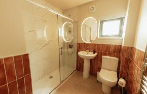 a bathroom with a shower and a toilet and a sink at The Seafield Arms Hotel Cullen - Self Catering in Cullen +42 photos