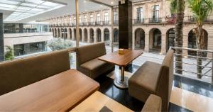 a restaurant with a table and chairs and a large window at Panorama in San Luis Potosí