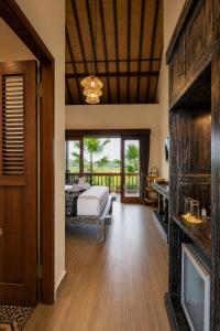 a master bedroom with a bed and a balcony at Villa Silas Ubud Bali in Ubud