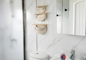 a bathroom with a toilet and a sink and a mirror at Box Villages Pecos in Pecos +96 photos