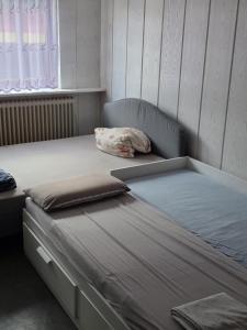 a bedroom with two beds and a window at Heritage Timber Stay in Wendeburg +3 photos