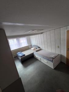 a bedroom with two beds and a window at Heritage Timber Stay in Wendeburg