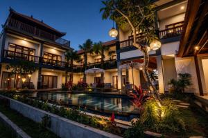 an exterior view of a resort with a swimming pool at Villa Silas Ubud Bali in Ubud