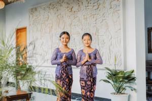 two women standing in front of a wall doing yoga at Villa Silas Ubud Bali in Ubud +38 photos