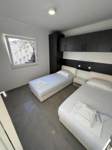 two beds in a small room with a window at Villa Omazic in Trogir +64 photos