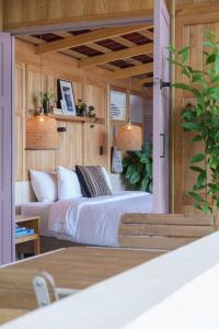 a bedroom with two beds and two pendant lights at Hotel Plantación in Jardin