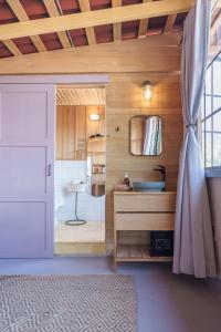 a bathroom with a sink and a toilet and a door at Hotel Plantación in Jardin