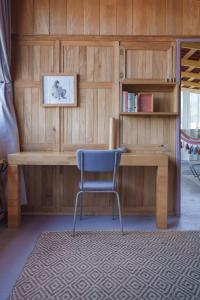 a blue chair sitting in front of a wooden desk at Hotel Plantación in Jardin +80 photos