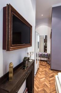 a living room with a flat screen tv on a wall at Vite Suites Guest House in Rome