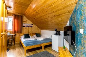 a bedroom with a bed in a wooden room at Fakanalas Fogadó in Pásztó