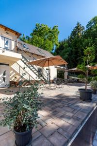 a patio with a staircase and an umbrella at Fakanalas Fogadó in Pásztó