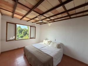 a bedroom with a large bed with a window at Tramuntana Sunset in Port de Soller