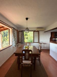 a dining room with a wooden table and chairs at Tramuntana Sunset in Port de Soller