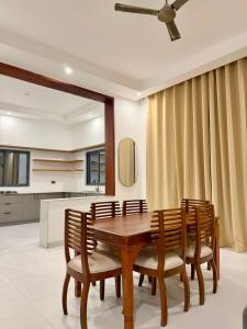 a dining room with a wooden table and chairs at Coral by Ivory Hotels in Mombasa
