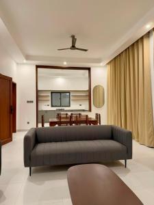 a living room with a couch and a table at Coral by Ivory Hotels in Mombasa