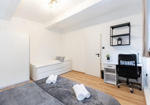 a bedroom with a bed and a desk and a chair at Calm Center Modern Apartment in Staré Mesto