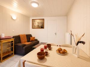 a living room with a table and a couch at Le St Joseph in Vérin