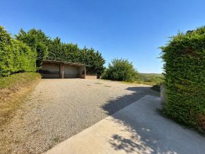 a driveway leading to a garage with a building at Le St Joseph in Vérin +11 photos