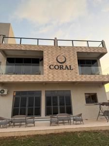 a group of benches in front of a building at Coral by Ivory Hotels in Mombasa