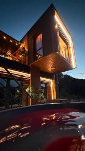a house with a reflection of a car in front of it at Bella Vista Cheia in Cheia