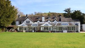 a large house with a large lawn in front of it at Plas Dolguog in Machynlleth