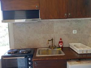 a kitchen counter with a sink and a stove at villa vitta - bellissimo villagio in Kastrákion +65 photos