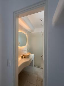 a bathroom with a sink and a shower at Gaia Mykonos Villas & Suites in Tagou +33 photos