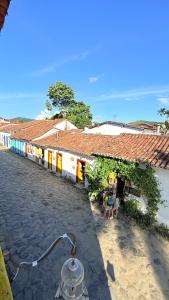 a group of people sitting in front of a building at Pousada Café e Prosa Centro Histórico Paraty in Paraty +17 photos