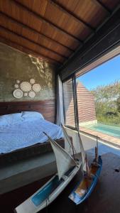 two chairs in a bedroom with a bed and a window at Contemporary architecture by the sea in Búzios
