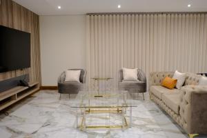 a living room with a couch and a tv at The ATRIUM BOUTIQUE HOTEL in Polokwane