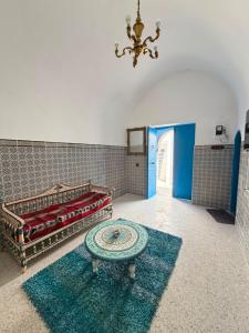 a room with a bed and a table in it at Dar Sarah in Kelibia