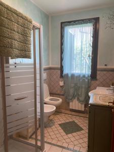 a bathroom with a toilet and a sink at Le case della baracchina in Pisa +41 photos