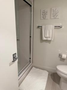 a bathroom with a shower and a toilet and towels at Private Dana Point Beach Studio in Dana Point +24 photos