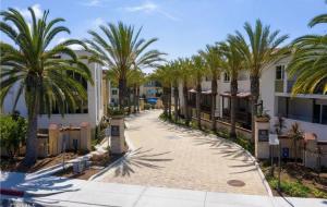 a walkway with palm trees in front of condos at Private Dana Point Beach Studio in Dana Point