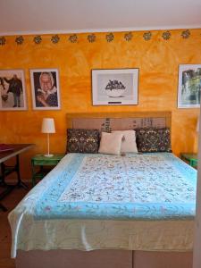 a bedroom with a bed with a blue comforter at Frida in Filipstad