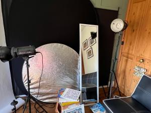 a camera and a mirror in a room at Relax in a Creative Art Space in Guildford