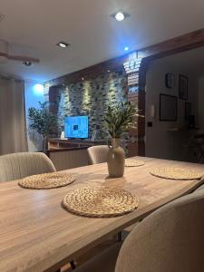a wooden table with chairs and a vase on it at Casa Carmen I in Montoro +2 photos