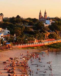 a group of people on a beach in the water at Esquina Hostel in Esquina